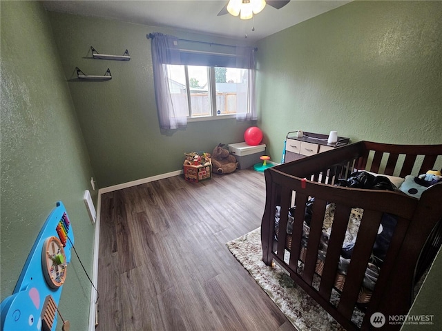 10915 Davisson Rd SW, Lakewood, WA 98499 - bedroom with wood finished floors, a textured wall, and a crib