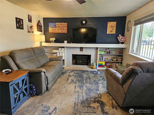 10915 Davisson Rd SW, Lakewood, WA 98499 - living area with ceiling fan, a tiled fireplace, and an accent wall
