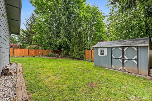 view of yard featuring a storage shed and an outbuilding