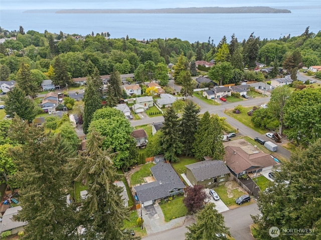 aerial view of property's location featuring nearby suburban area and a large body of water