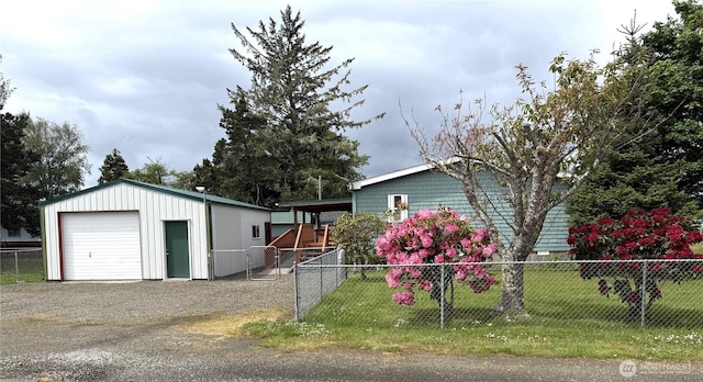 1710 263rd St, Ocean Park, WA 98640 - view of front of home featuring a detached garage, an outbuilding, and gravel driveway