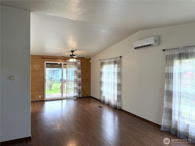 1710 263rd St, Ocean Park, WA 98640 - empty room featuring a wall mounted air conditioner, a ceiling fan, lofted ceiling, wood finished floors, and baseboards