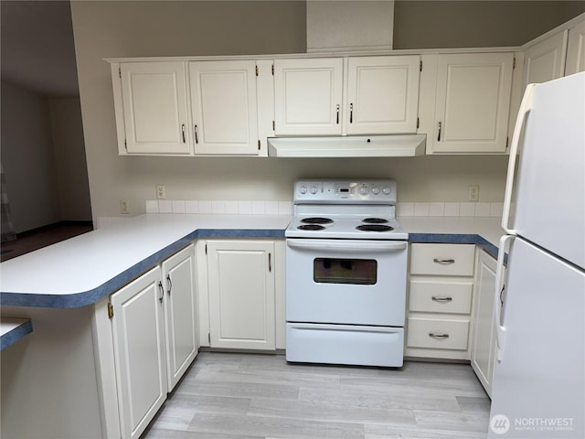 1710 263rd St, Ocean Park, WA 98640 - kitchen featuring white appliances, under cabinet range hood, white cabinetry, a peninsula, and light wood-style floors
