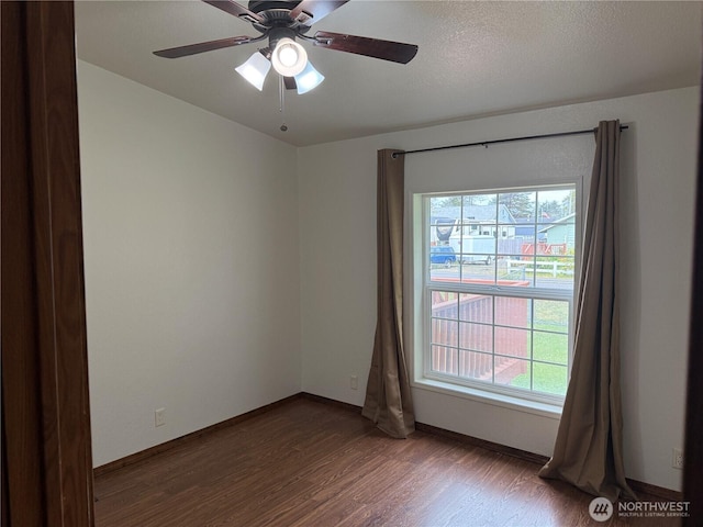 1710 263rd St, Ocean Park, WA 98640 - unfurnished room featuring wood finished floors, healthy amount of natural light, a ceiling fan, and baseboards