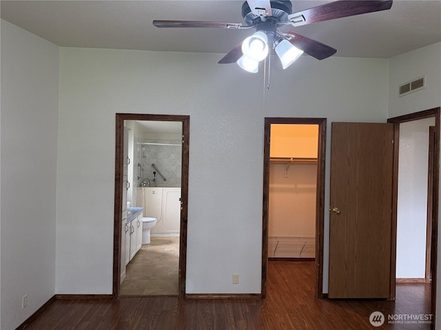 1710 263rd St, Ocean Park, WA 98640 - unfurnished bedroom with a walk in closet, a closet, wood finished floors, baseboards, and ensuite bath