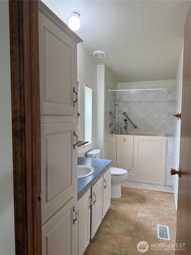 1710 263rd St, Ocean Park, WA 98640 - full bathroom featuring toilet, vanity, a shower, a textured ceiling, and a tub