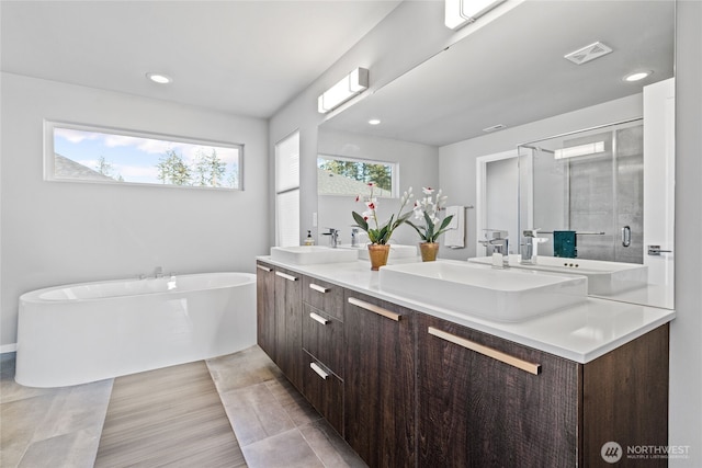 2553 Vardon Cir SW, Port Orchard, WA 98367 - full bath with a shower stall, double vanity, a freestanding tub, and recessed lighting