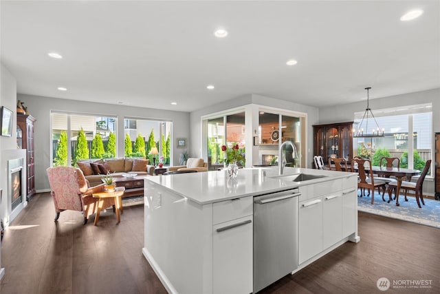 2553 Vardon Cir SW, Port Orchard, WA 98367 - kitchen featuring dishwasher, a sink, open floor plan, dark wood-style floors, and a center island with sink