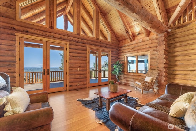 1831 Cottontail Ln, Chelan, WA 98816 - living room with french doors, high vaulted ceiling, wood ceiling with exposed beams, healthy amount of natural light, and log walls