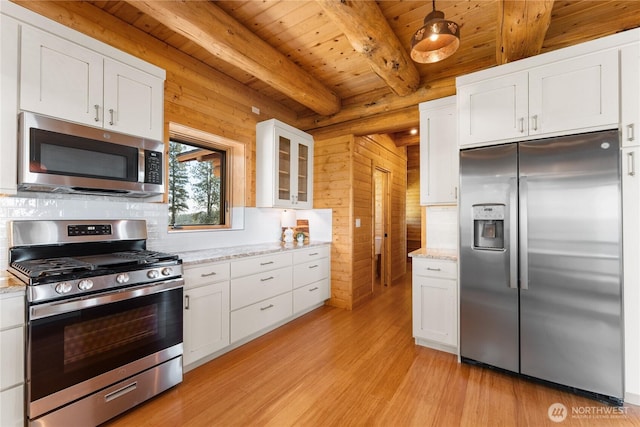 1831 Cottontail Ln, Chelan, WA 98816 - kitchen featuring stainless steel appliances, light wood finished floors, backsplash, white cabinetry, and wood ceiling with exposed beams