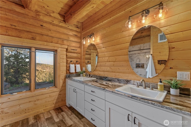 1831 Cottontail Ln, Chelan, WA 98816 - bathroom with double vanity, wood ceiling with exposed beams, wooden walls, and wood finished floors