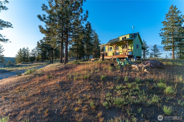 1831 Cottontail Ln, Chelan, WA 98816 - rear view of property featuring a deck, board and batten siding, and metal roof