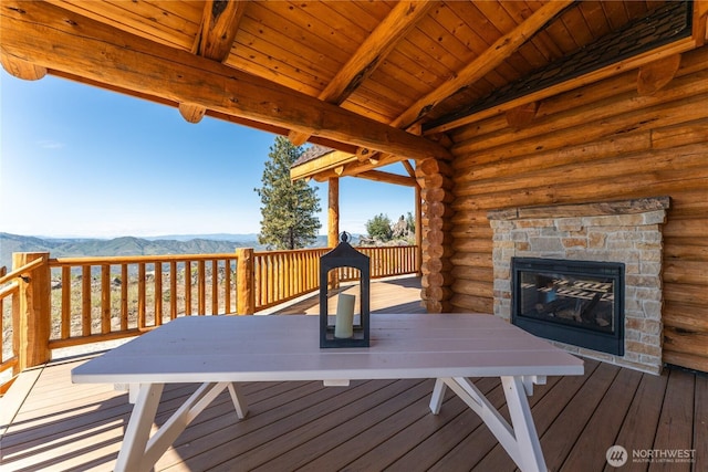 1831 Cottontail Ln, Chelan, WA 98816 - deck featuring an outdoor stone fireplace and a mountain view