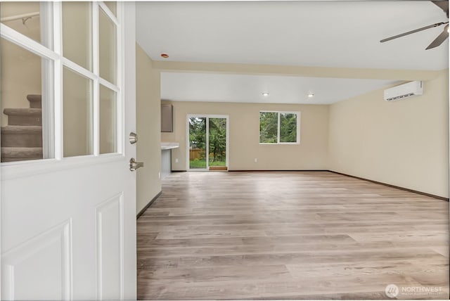 20116 58th Ave E, Spanaway, WA 98387 - empty room featuring ceiling fan, light wood-type flooring, a wall mounted AC, and baseboards