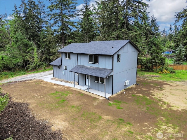 20116 58th Ave E, Spanaway, WA 98387 - view of front of house featuring roof with shingles, a porch, board and batten siding, and dirt driveway