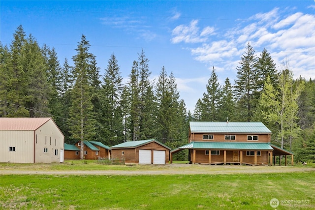 4193 Sparks Rd, Easton, WA 98925 - back of house with a porch, an outbuilding, a detached garage, and a yard
