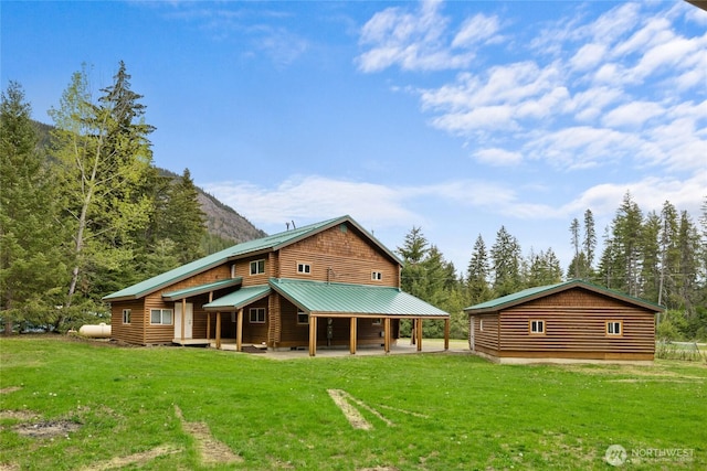 4193 Sparks Rd, Easton, WA 98925 - back of house with a lawn, log veneer siding, metal roof, and a patio area