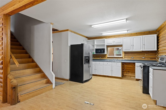 4193 Sparks Rd, Easton, WA 98925 - kitchen with stainless steel appliances, open shelves, white cabinetry, and light wood-style flooring