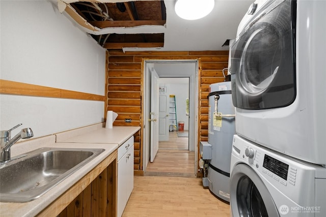 4193 Sparks Rd, Easton, WA 98925 - laundry room with log walls, estacked washer and dryer, light wood-style floors, and water heater