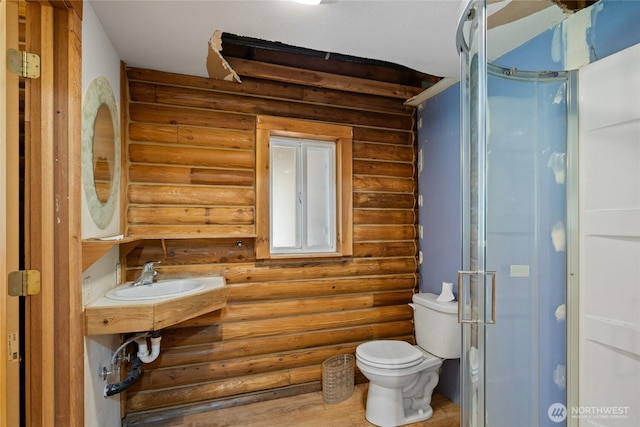 4193 Sparks Rd, Easton, WA 98925 - bathroom with a sink, log walls, a shower stall, and toilet