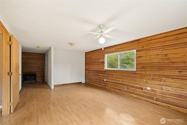 4193 Sparks Rd, Easton, WA 98925 - unfurnished living room with a fireplace, ceiling fan, light wood finished floors, and baseboards