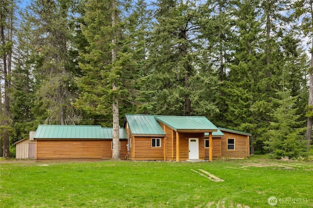 4193 Sparks Rd, Easton, WA 98925 - view of front facade with a front yard, an outbuilding, metal roof, and a view of trees