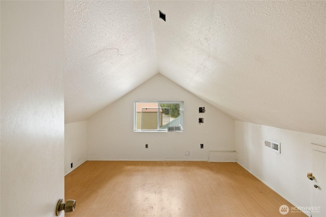 4193 Sparks Rd, Easton, WA 98925 - bonus room with light wood-style floors, a textured ceiling, vaulted ceiling, and baseboards