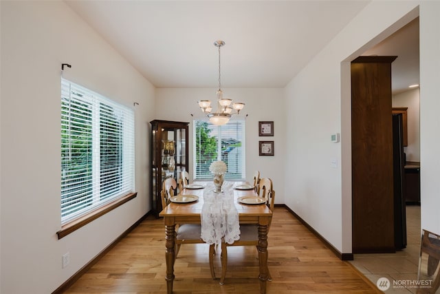 3323 Appaloosa Way, Bremerton, WA 98310 - dining space with healthy amount of natural light, a chandelier, light wood-type flooring, and baseboards
