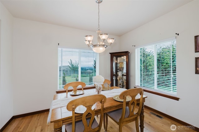 3323 Appaloosa Way, Bremerton, WA 98310 - dining room featuring a chandelier, light wood-type flooring, and baseboards