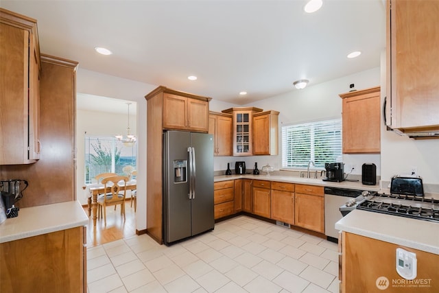 3323 Appaloosa Way, Bremerton, WA 98310 - kitchen with appliances with stainless steel finishes, a chandelier, a sink, light countertops, and glass insert cabinets