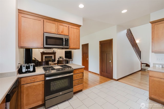 3323 Appaloosa Way, Bremerton, WA 98310 - kitchen featuring appliances with stainless steel finishes, light countertops, recessed lighting, light wood-style floors, and a peninsula