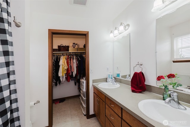 3323 Appaloosa Way, Bremerton, WA 98310 - bathroom featuring double vanity, tile patterned floors, a spacious closet, and curtained shower