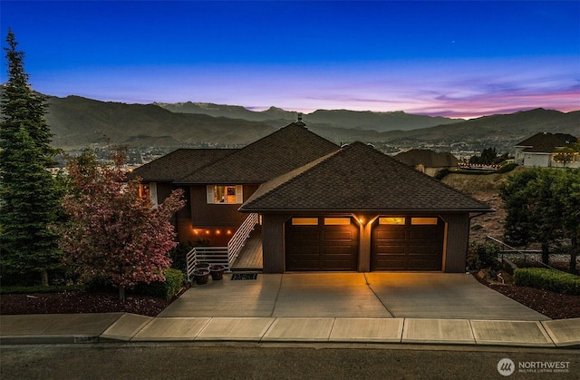 2336 Grand Ave, East Wenatchee, WA 98802 - view of front of house with a mountain view, an attached garage, driveway, and a shingled roof