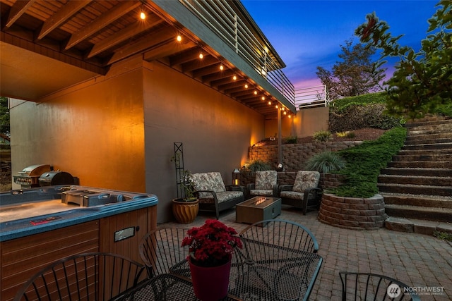 2336 Grand Ave, East Wenatchee, WA 98802 - patio terrace at dusk featuring a patio area, stairs, an outdoor hot tub, and an outdoor living space with a fire pit
