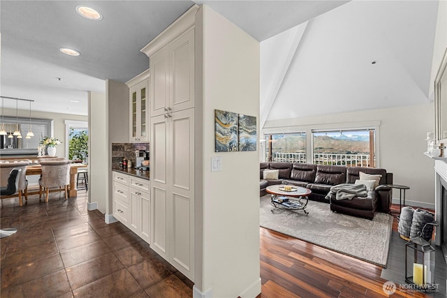 2336 Grand Ave, East Wenatchee, WA 98802 - bar featuring baseboards, tasteful backsplash, recessed lighting, and a towering ceiling
