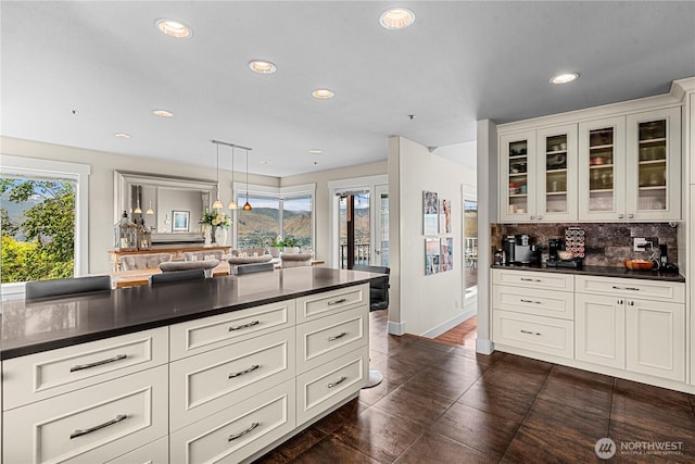 2336 Grand Ave, East Wenatchee, WA 98802 - kitchen with dark countertops, plenty of natural light, glass insert cabinets, recessed lighting, and tasteful backsplash