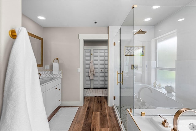 2336 Grand Ave, East Wenatchee, WA 98802 - full bath featuring vanity, a stall shower, a garden tub, wood finished floors, and baseboards