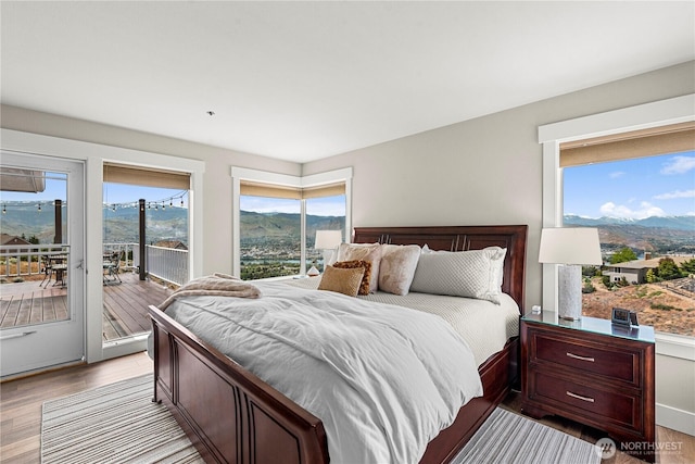 2336 Grand Ave, East Wenatchee, WA 98802 - bedroom with access to outside, light wood-style floors, a mountain view, and multiple windows