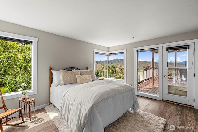 2336 Grand Ave, East Wenatchee, WA 98802 - bedroom featuring access to outside, wood finished floors, a mountain view, and baseboards