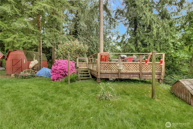 32030 83rd Dr NW, Stanwood, WA 98292 - view of green lawn with a shed, a deck, and an outbuilding