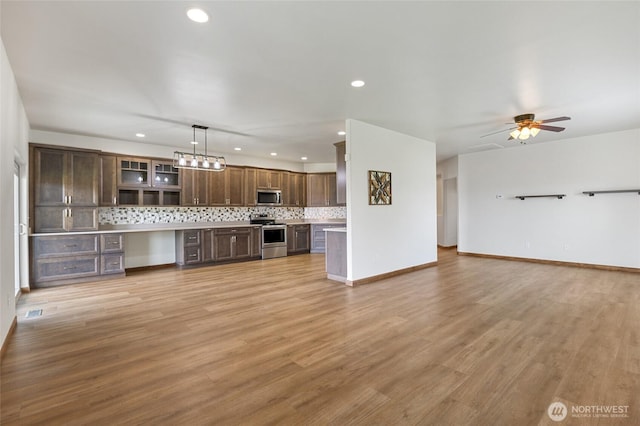 121 Scenic Dr NE, Moses Lake, WA 98837 - unfurnished living room with recessed lighting, light wood finished floors, a ceiling fan, and baseboards