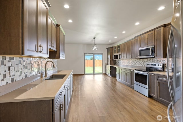 121 Scenic Dr NE, Moses Lake, WA 98837 - kitchen featuring appliances with stainless steel finishes, a sink, backsplash, light wood-type flooring, and recessed lighting