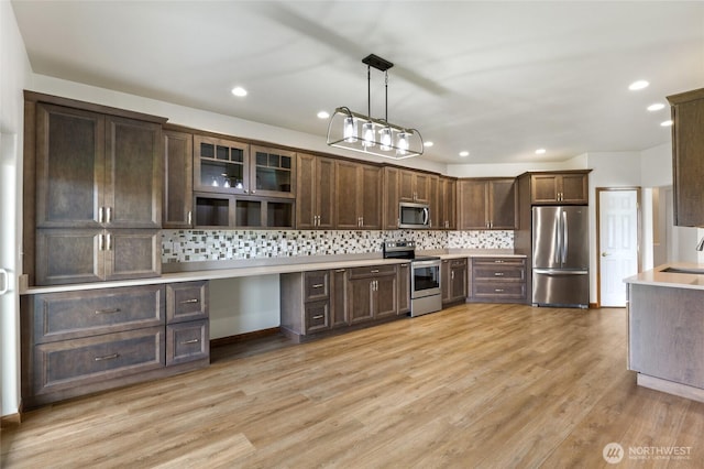 121 Scenic Dr NE, Moses Lake, WA 98837 - kitchen featuring appliances with stainless steel finishes, dark brown cabinets, light countertops, tasteful backsplash, and recessed lighting