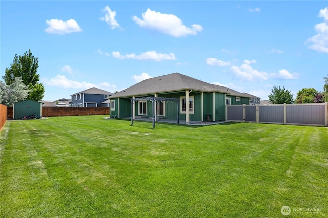 121 Scenic Dr NE, Moses Lake, WA 98837 - back of property with a storage unit, an outbuilding, a patio area, and a gate