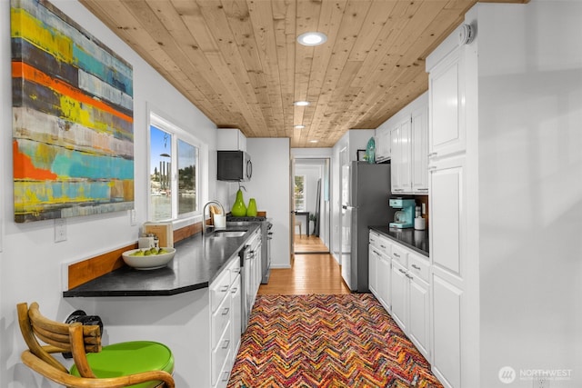 1900 N Westlake Ave N Unit 01Do7, Seattle, WA 98109 - kitchen with wooden ceiling, a sink, dark countertops, recessed lighting, and stainless steel appliances
