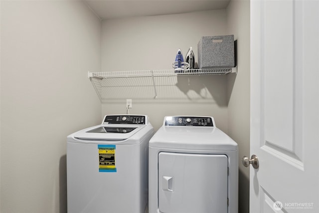 washroom featuring washer and clothes dryer