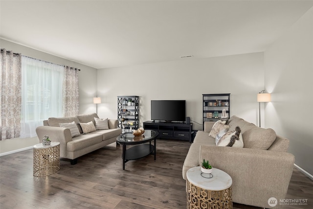living room featuring dark wood-style floors and baseboards