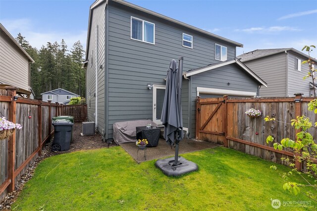 back of property featuring central air condition unit and a garage