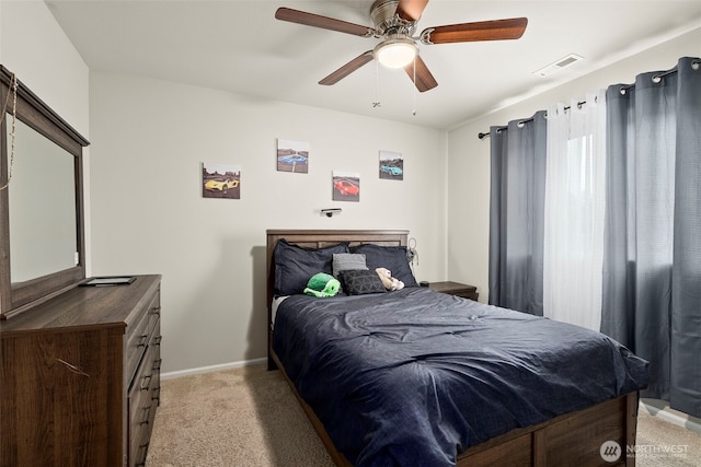bedroom with light colored carpet, baseboards, and ceiling fan