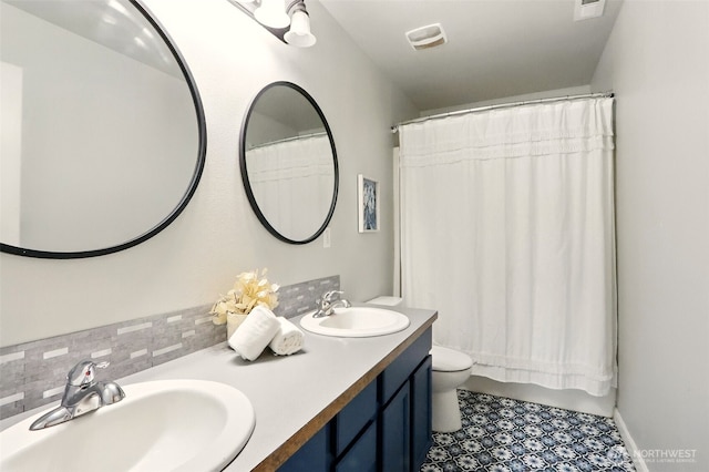 2514 164th St E, Tacoma, WA 98445 - bathroom featuring double vanity, toilet, tile patterned flooring, and decorative backsplash